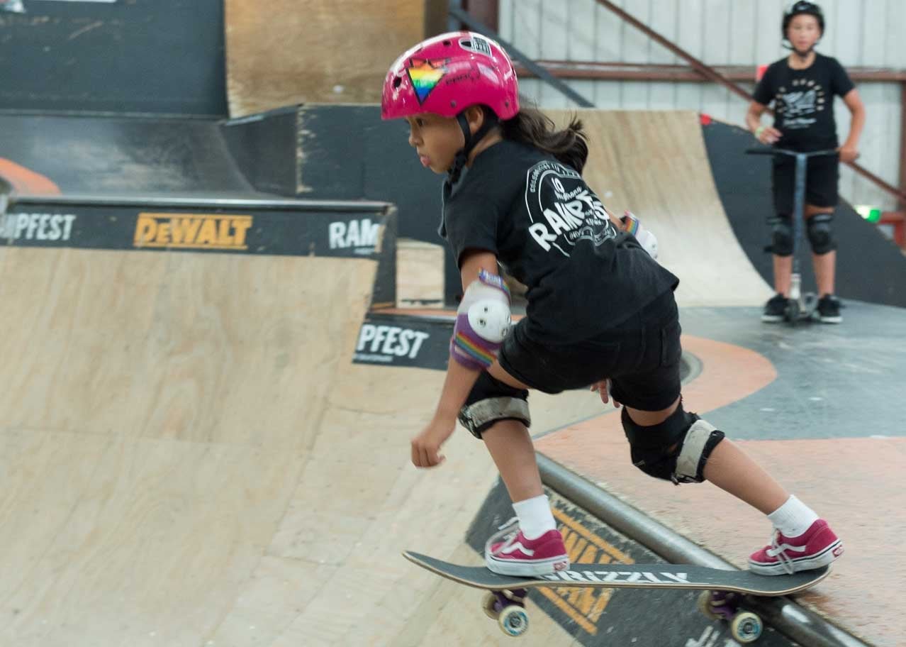 Young Skater Girl dropping in at RampFest for a School Sports Program Excursion.