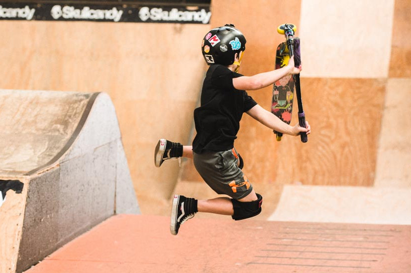 Freestyle Scooter Rider doing a flyout Scooter Trick during a Coaching Session at RampFest.